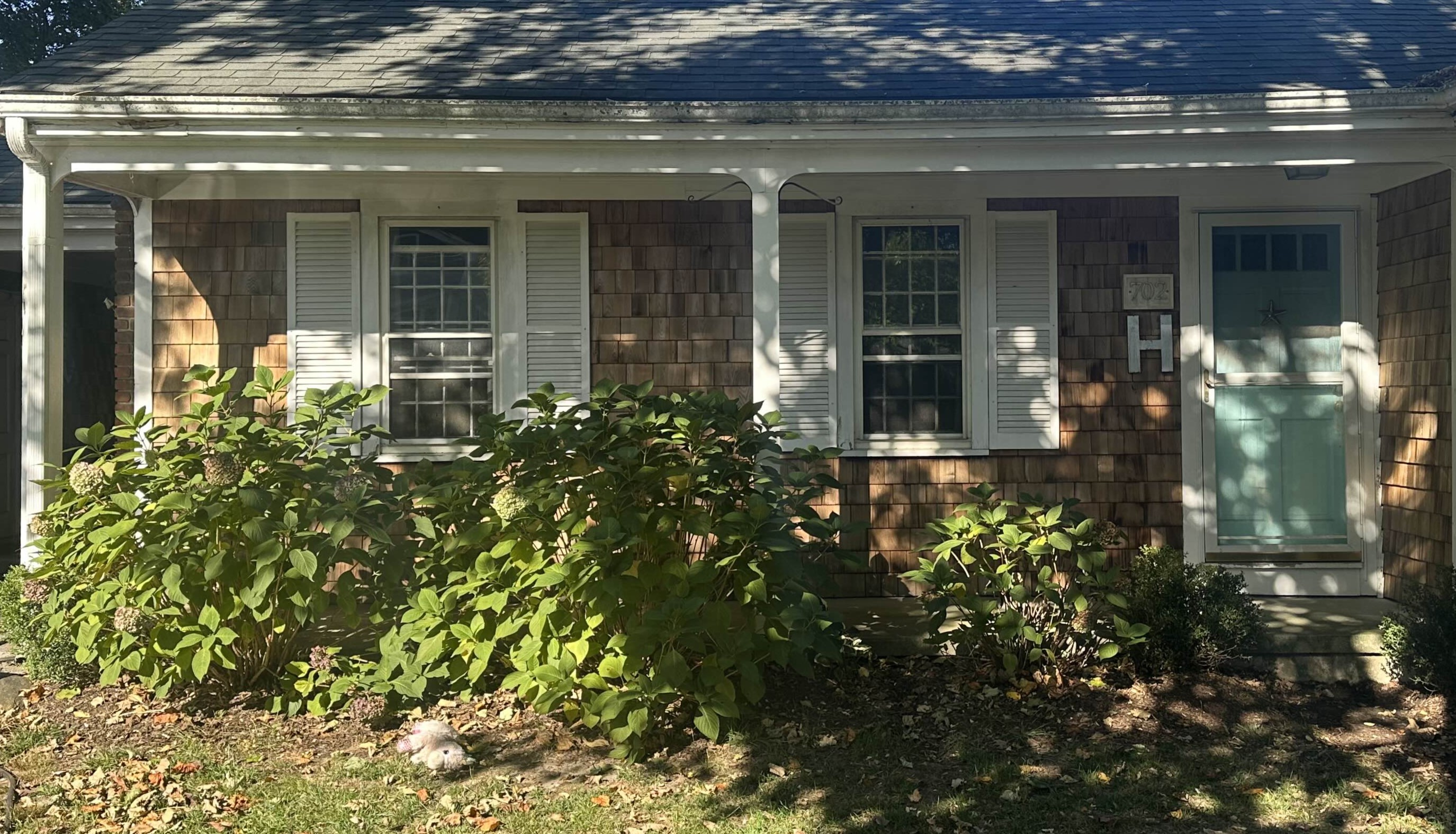 Cedar shake siding front of house after professional cleaning Middletown RI - restored warm natural cedar tones