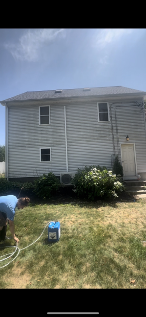 Two-story house vinyl siding before cleaning Bradford RI - weathered gray and discolored siding