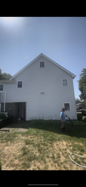 Two-story house vinyl siding after professional cleaning Bradford RI - bright white and pristine condition