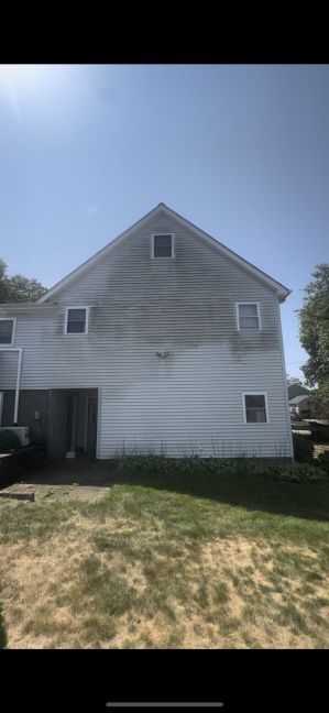 Two-story house vinyl siding before cleaning Bradford RI - discolored and weathered appearance