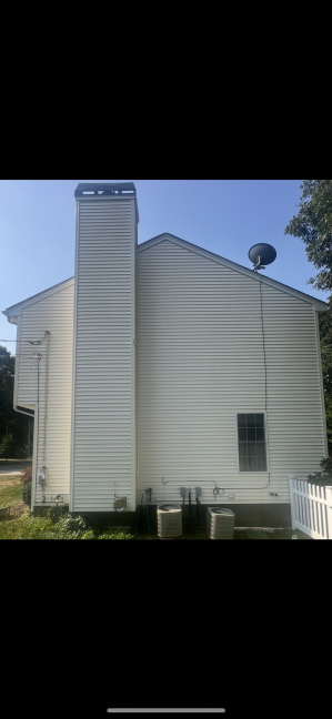 House vinyl siding after professional cleaning Cranston RI - bright white and pristine condition