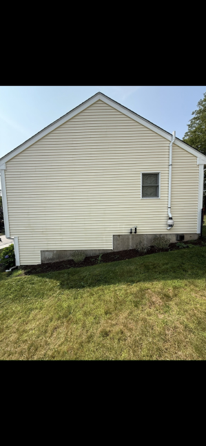 House vinyl siding after professional cleaning Warwick RI - bright white and pristine condition
