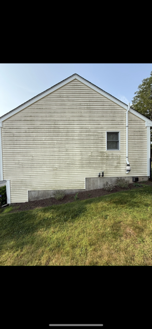 House vinyl siding before cleaning Warwick RI - weathered and discolored with algae and environmental staining