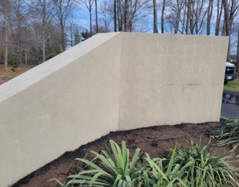 Stucco wall after professional pressure washing Groton CT - clean and restored to original color